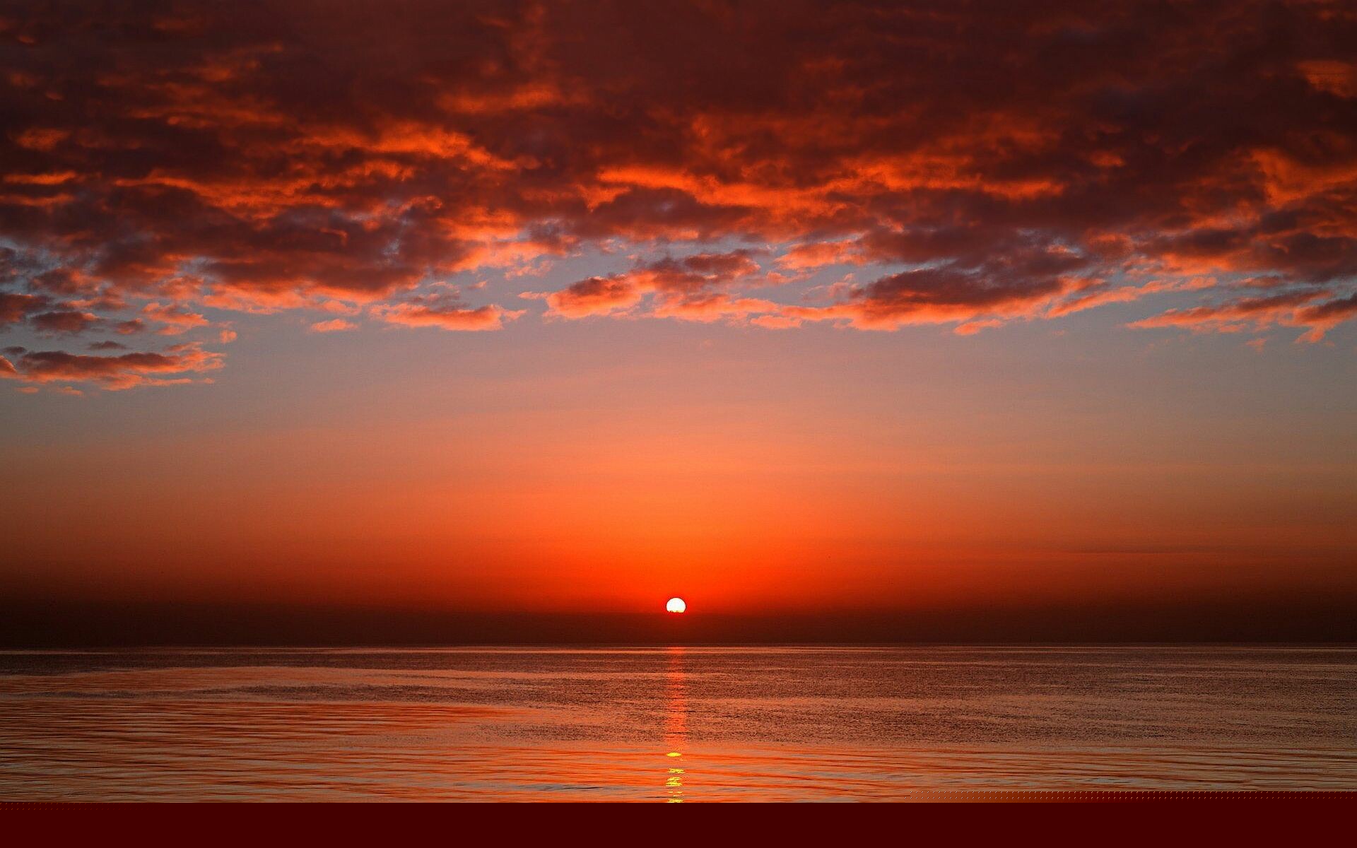 Sun on horizon, Crimson cloud streaks, Ocean sunset reflection Sun on horizon, Crimson cloud streaks, Ocean sunset reflection — 1920×1200 HD wallpaper