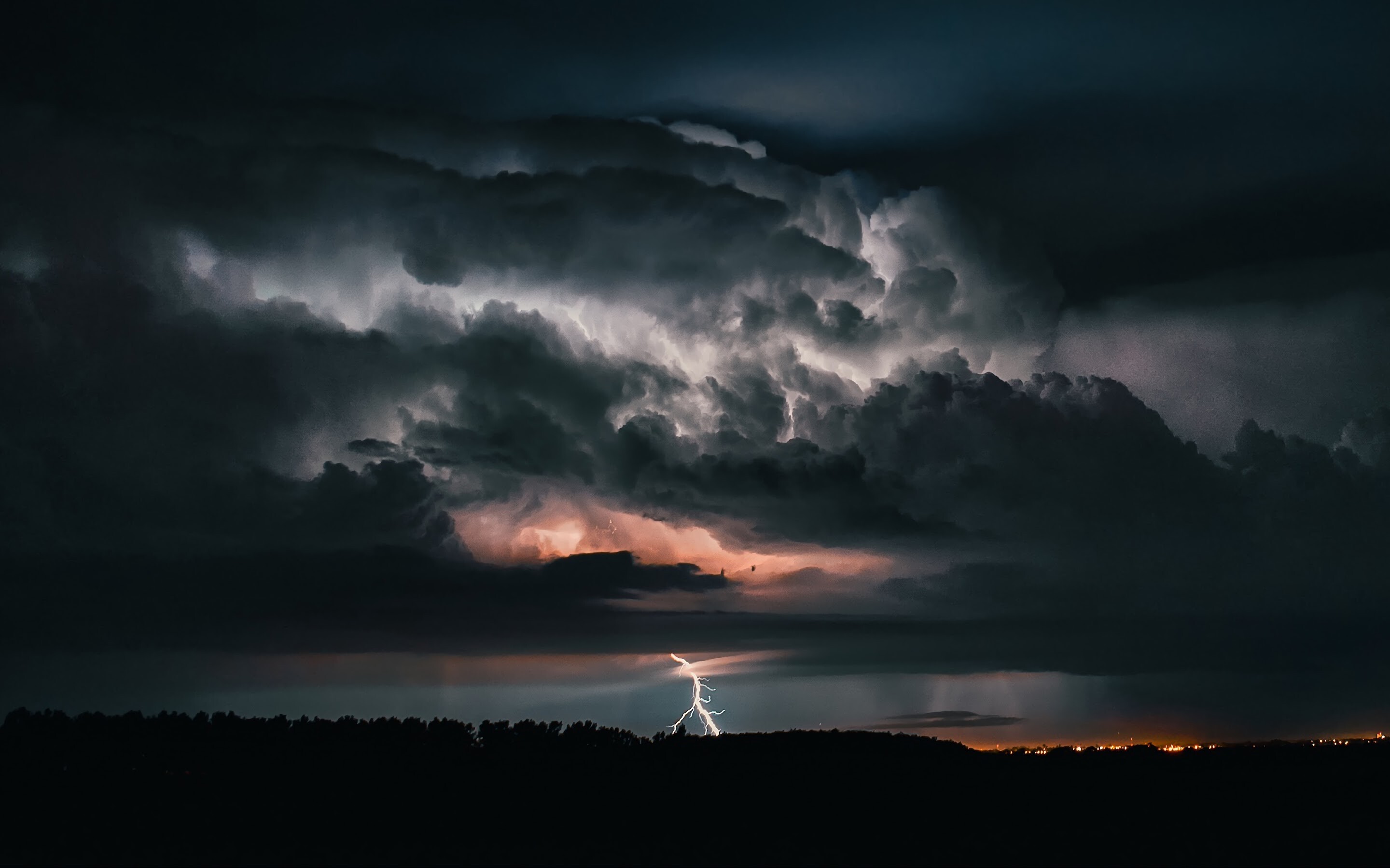 Lightning bolt strike, Supercell storm clouds, Distant town lights Lightning bolt strike, Supercell storm clouds, Distant town lights — 2880×1800 HD wallpaper