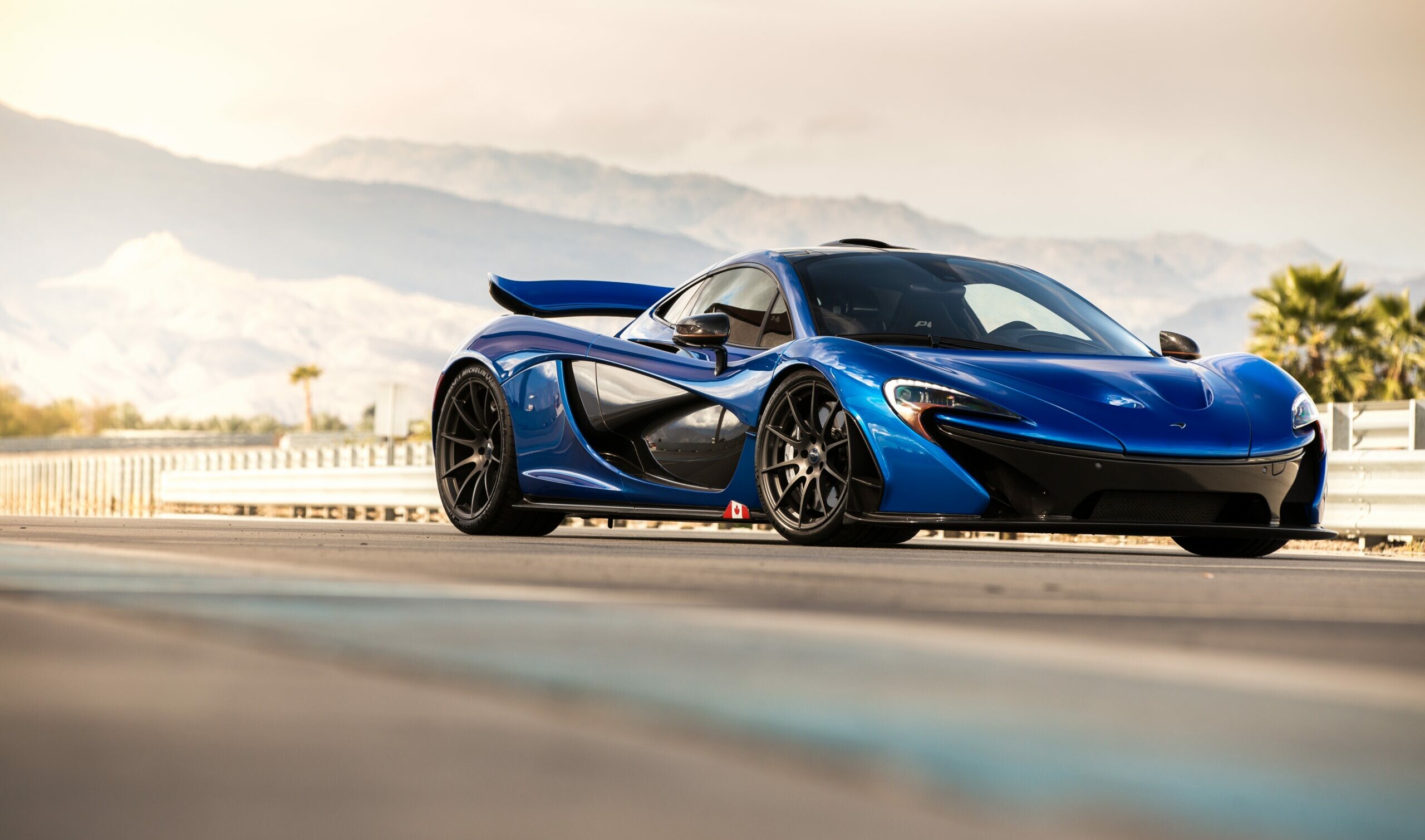 McLaren P1, Blue supercar, Desert mountain backdrop, Palm trees McLaren P1, Blue supercar, Desert mountain backdrop, Palm trees — 2560×1509 HD wallpaper