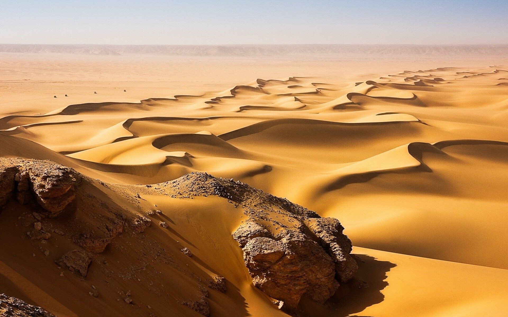 Sahara sand dunes, Weathered rock outcrop, Hazy desert horizon Sahara sand dunes, Weathered rock outcrop, Hazy desert horizon — 1920×1200 HD wallpaper