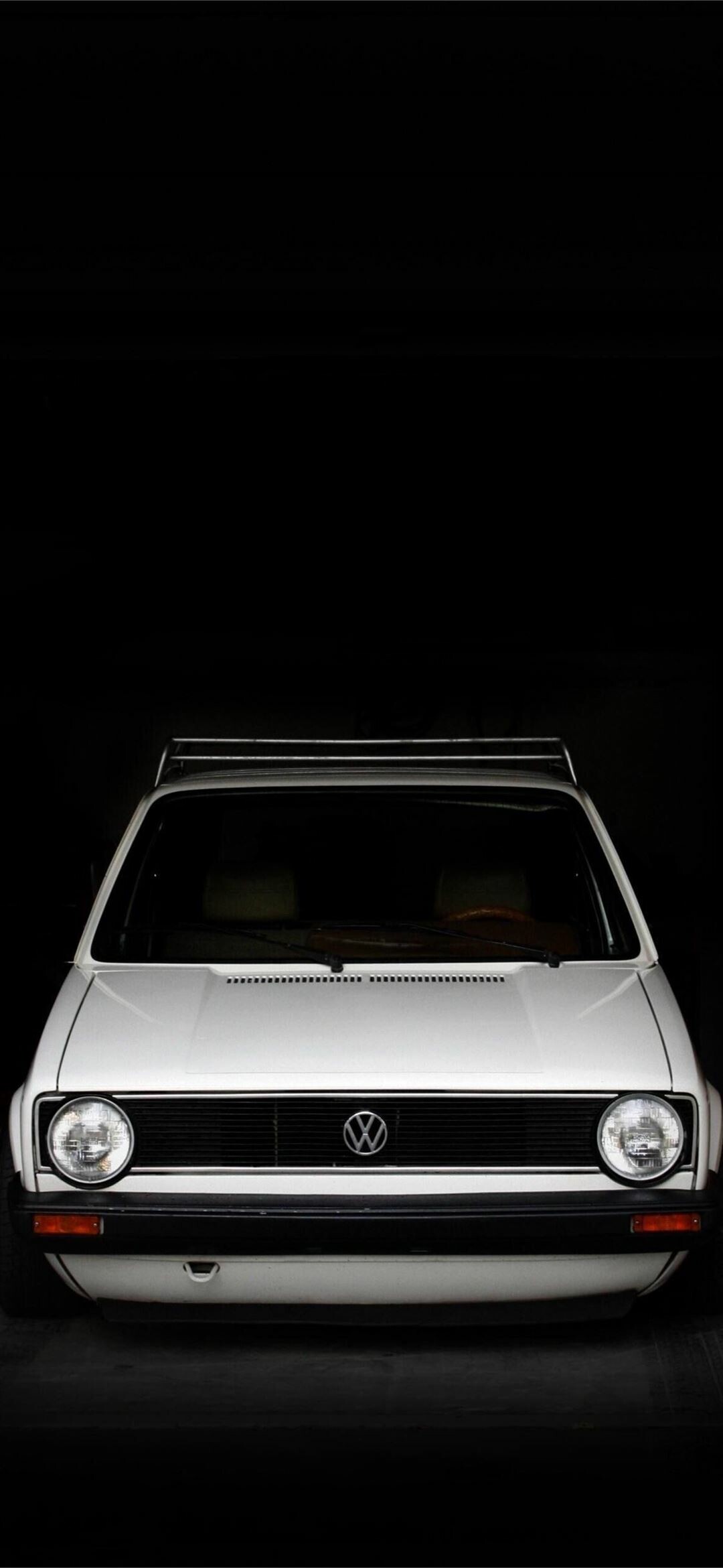 Volkswagen Golf Mk1, White hatchback front, Dark studio backdrop Volkswagen Golf Mk1, White hatchback front, Dark studio backdrop — 1080×2340 HD wallpaper