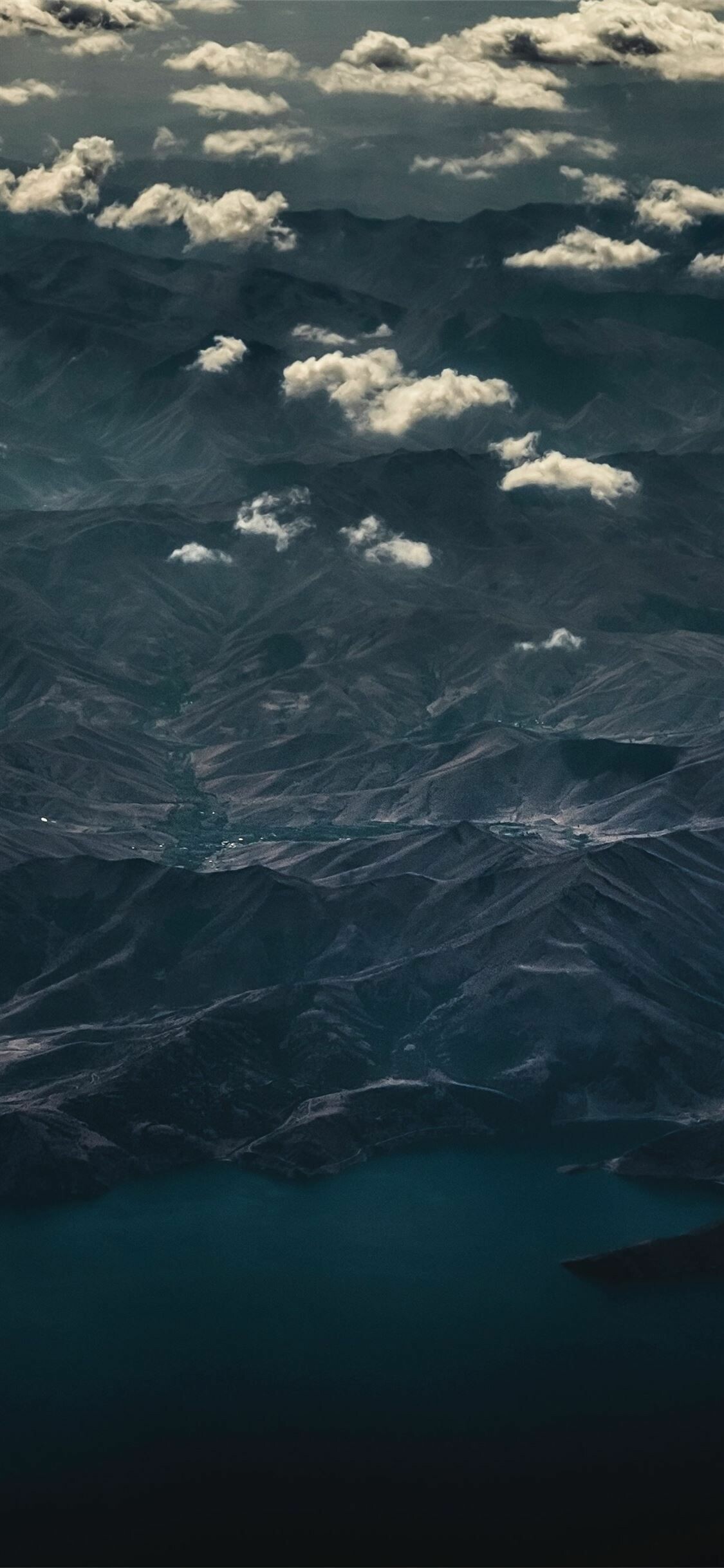 Aerial mountain range, Scattered cumulus clouds, Dark teal lake Aerial mountain range, Scattered cumulus clouds, Dark teal lake — 1125×2436 HD wallpaper