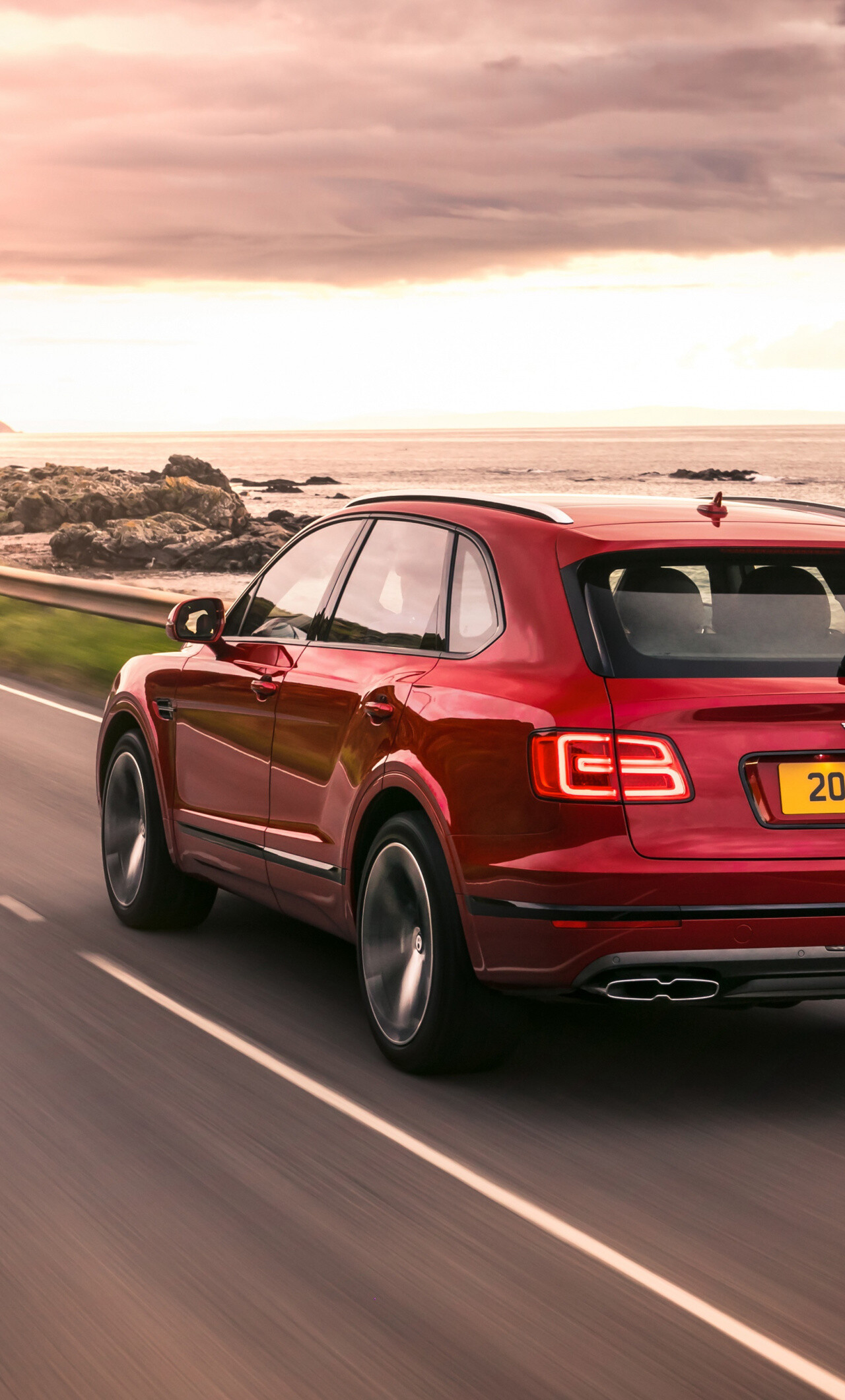 Bentley Bentayga, Coastal road sunset, Rocky ocean shoreline — 1280×2120 HD wallpaper