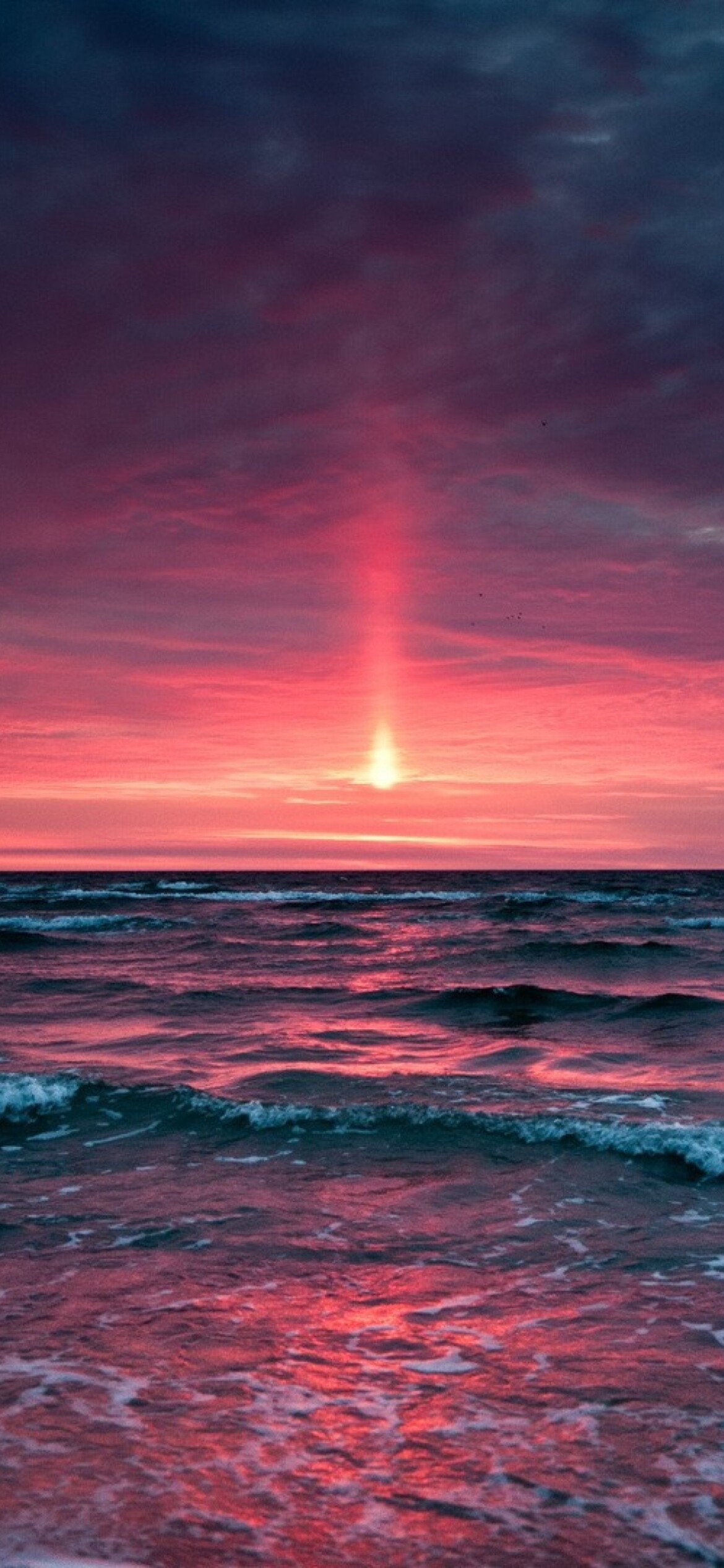 Pink ocean sunset, Vertical light pillar, Crimson wave reflections Pink ocean sunset, Vertical light pillar, Crimson wave reflections — 1170×2532 HD wallpaper