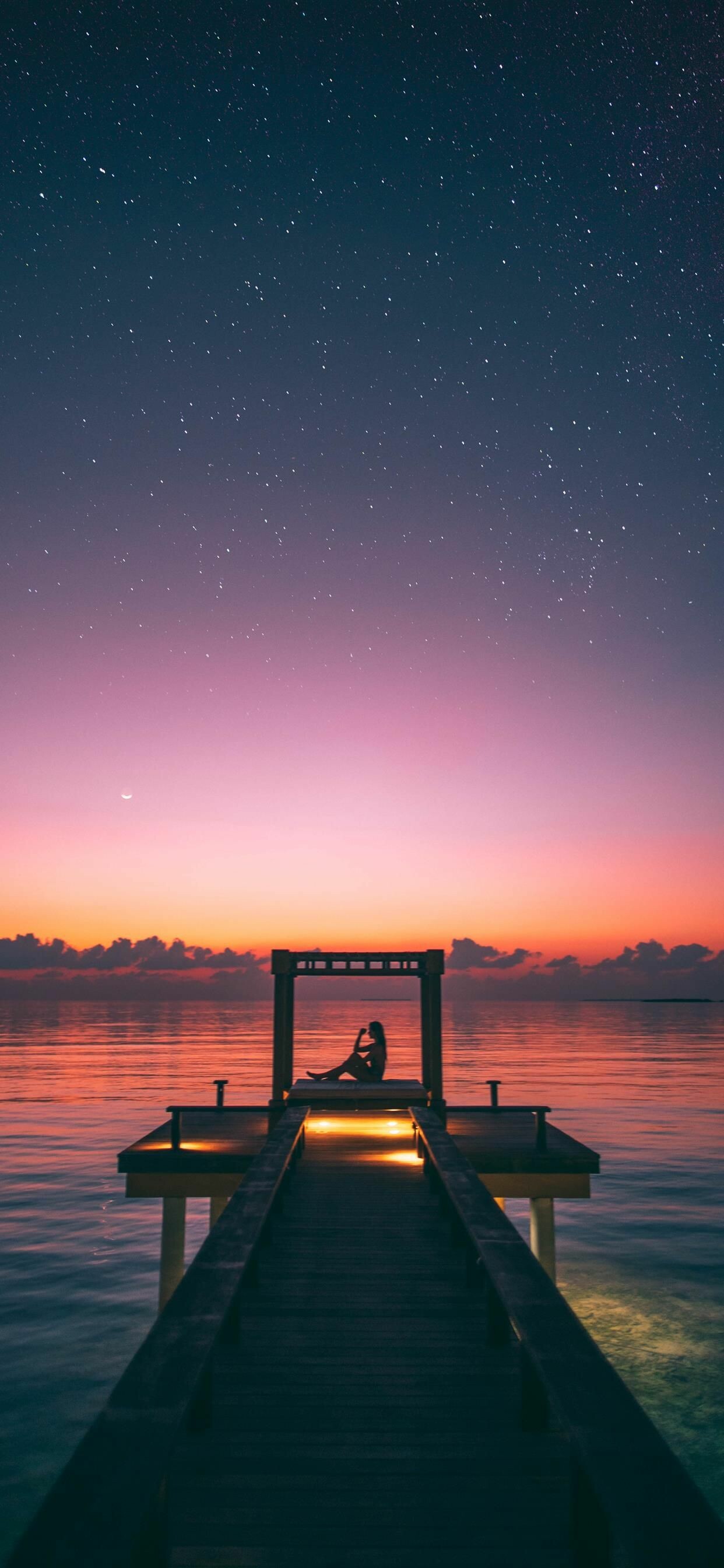 Maldives overwater jetty, Silhouetted person gazebo, Starry twilight sky Maldives overwater jetty, Silhouetted person gazebo, Starry twilight sky — 1242×2688 HD wallpaper