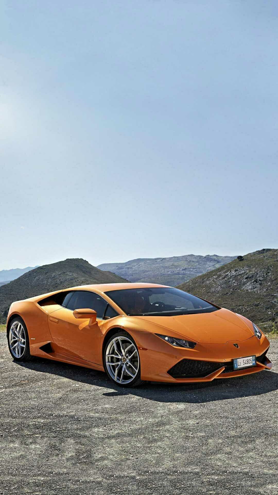 Orange Lamborghini Huracan, Front three-quarter parked, Rocky mountain backdrop Orange Lamborghini Huracan, Front three-quarter parked, Rocky mountain backdrop — 1080×1920 mobile wallpaper