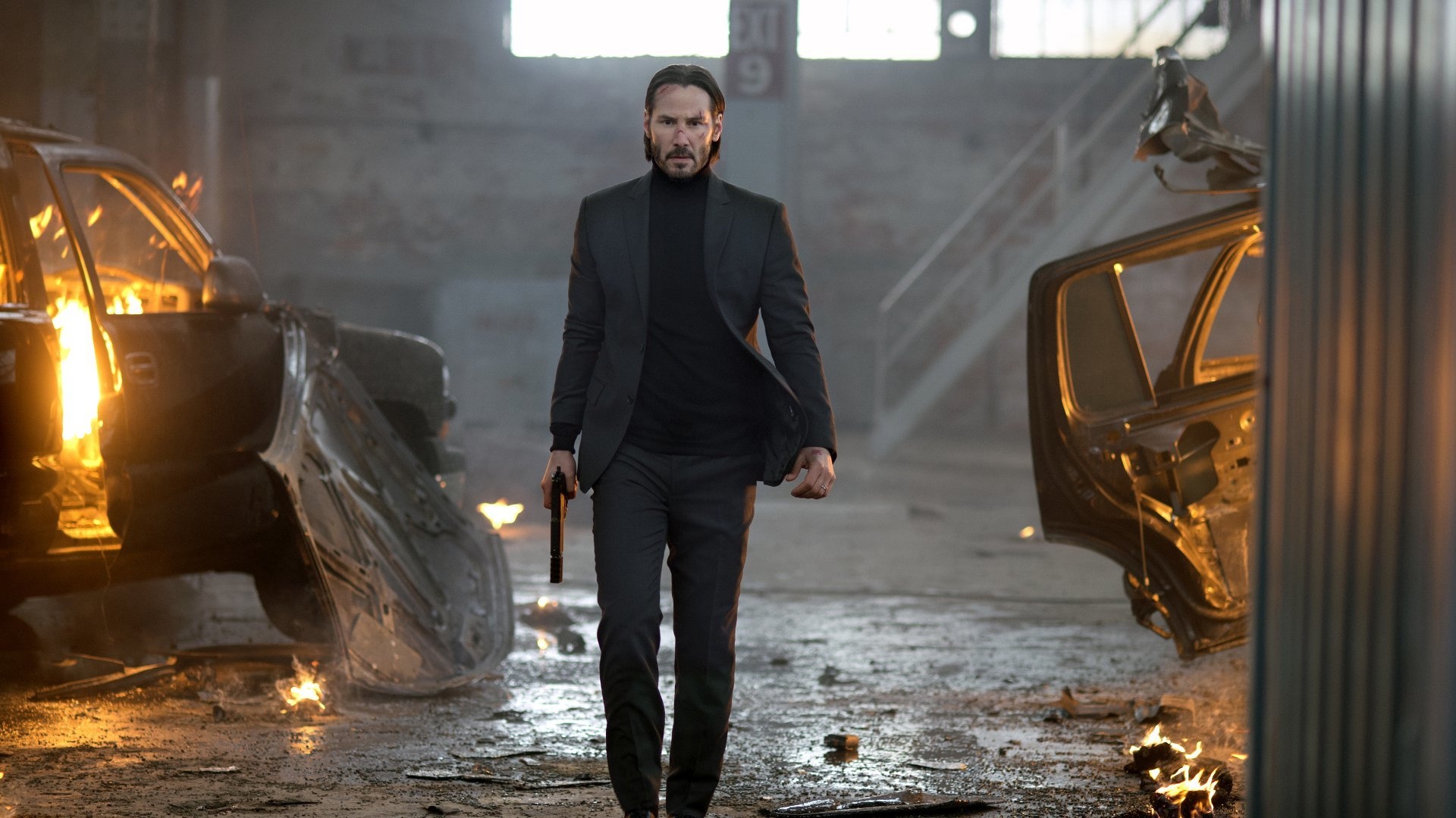 Keanu Reeves as John Wick, Burning wrecked cars, Industrial warehouse — 1920×1080 mobile wallpaper
