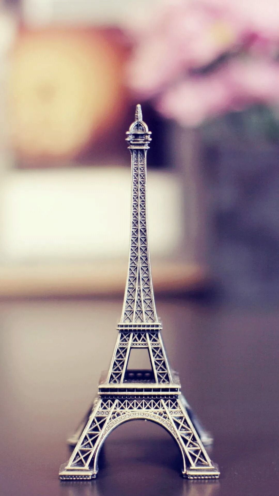 Eiffel Tower figurine, Wooden table souvenir, Soft pink bokeh — 1080×1920 HD wallpaper