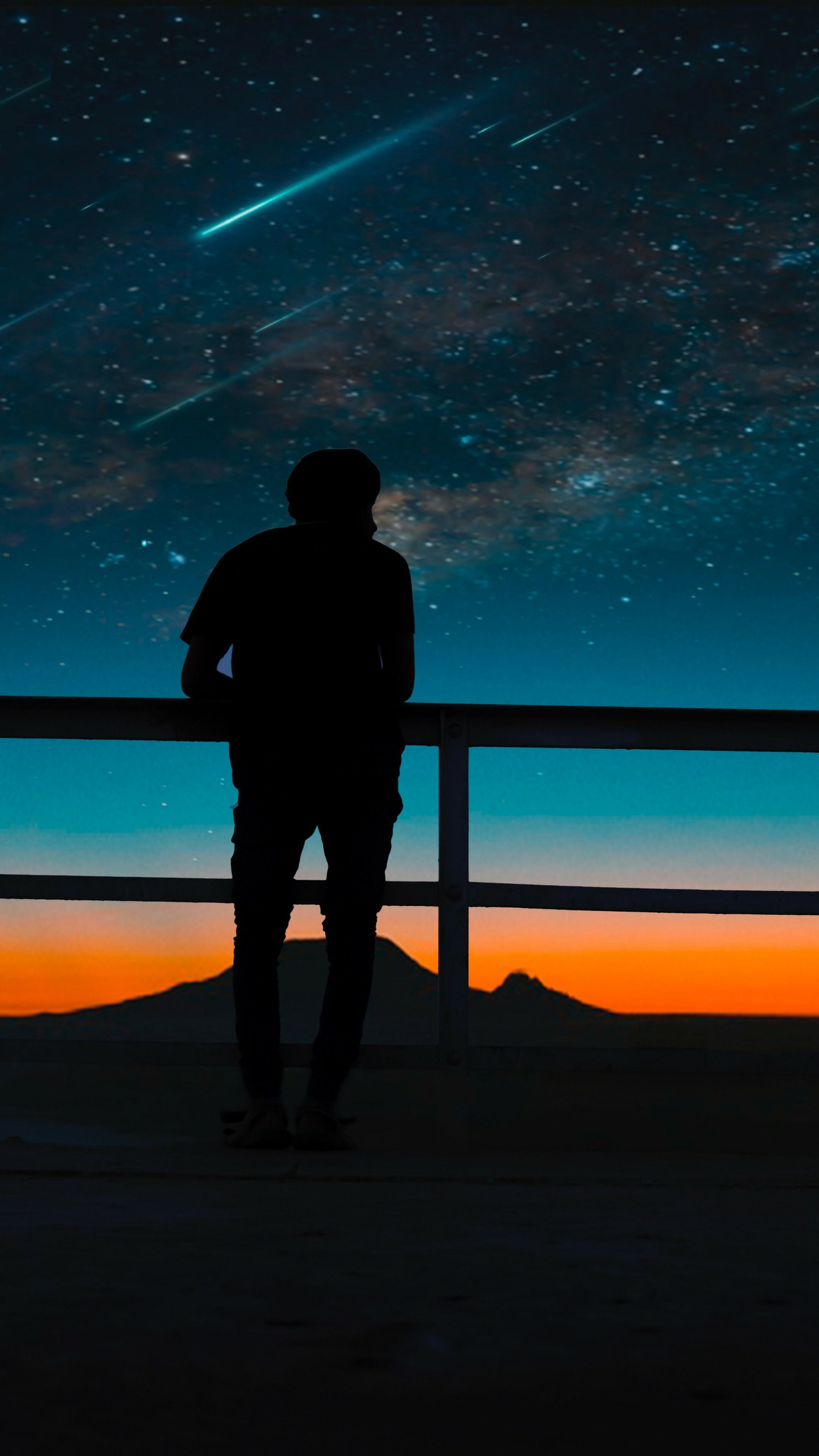 Silhouetted man at railing, Meteor shower streaks, Starry twilight sky, Distant mountain horizon — 2160×3840 HD wallpaper