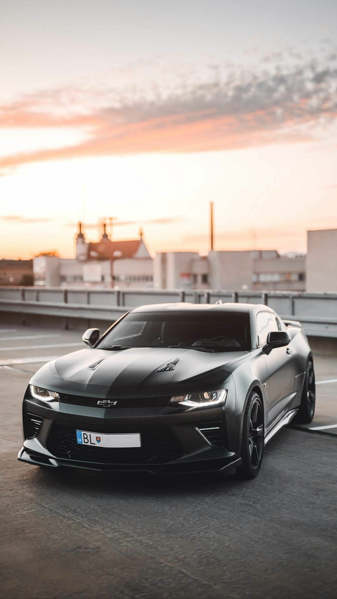 Chevrolet Camaro SS, Rooftop parking sunset, Matte black coupe Chevrolet Camaro SS, Rooftop parking sunset, Matte black coupe — 1152×2048 HD wallpaper