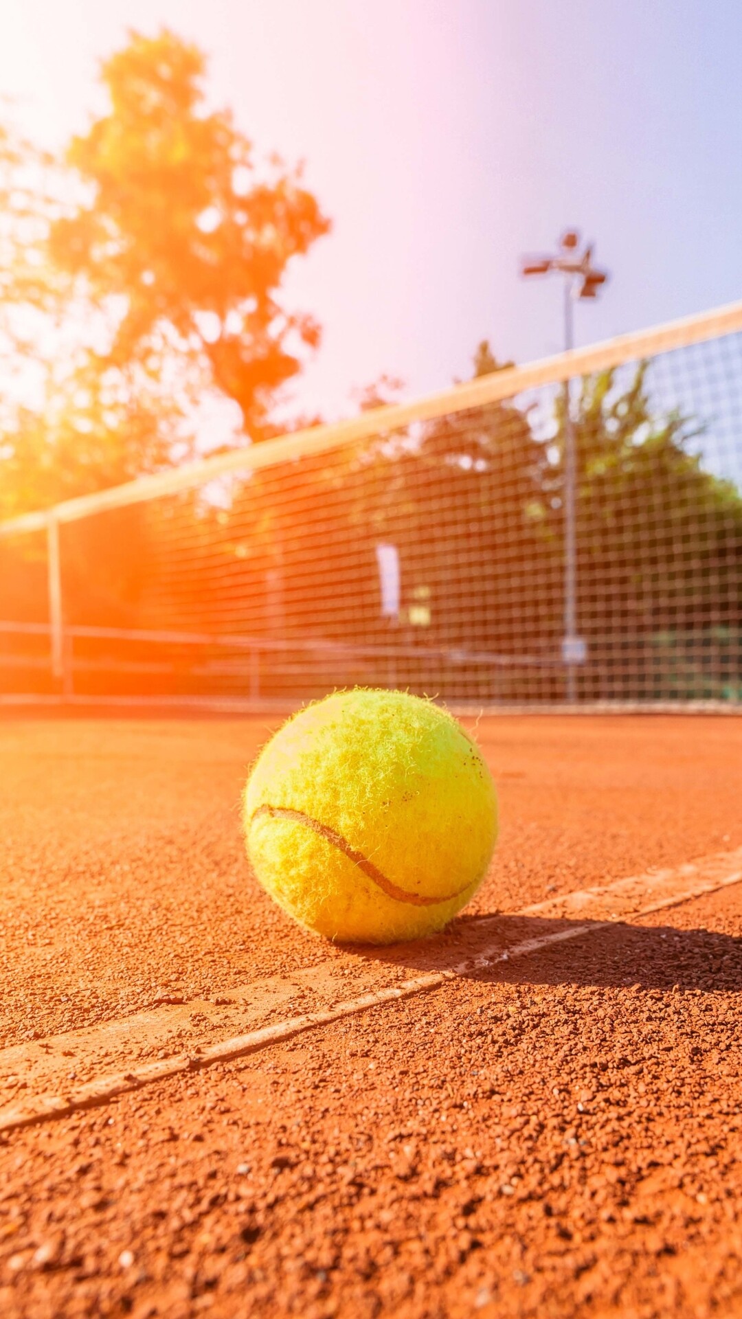 Yellow tennis ball, Clay court net, Sunset court lighting Yellow tennis ball, Clay court net, Sunset court lighting — 1080×1920 HD wallpaper