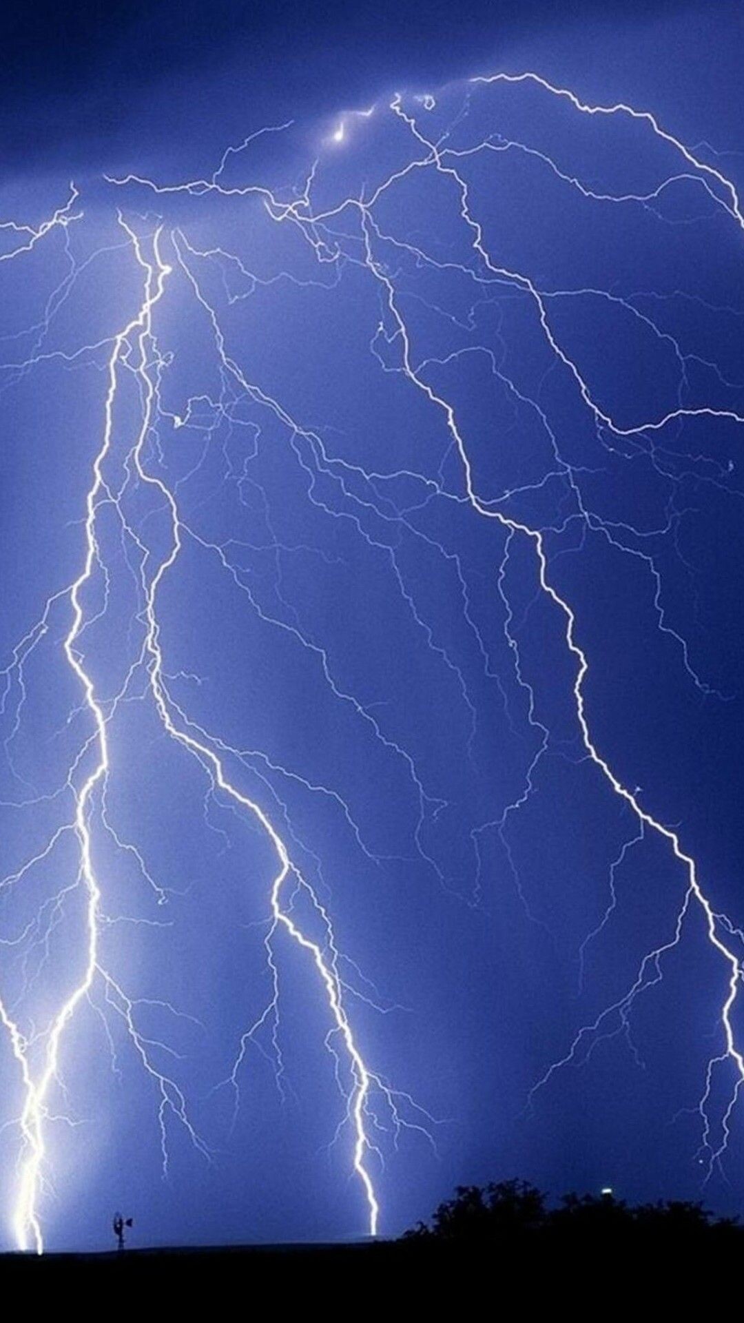 Forked lightning bolts, Dark stormy sky, Silhouetted ground horizon Forked lightning bolts, Dark stormy sky, Silhouetted ground horizon — 1080×1920 HD wallpaper