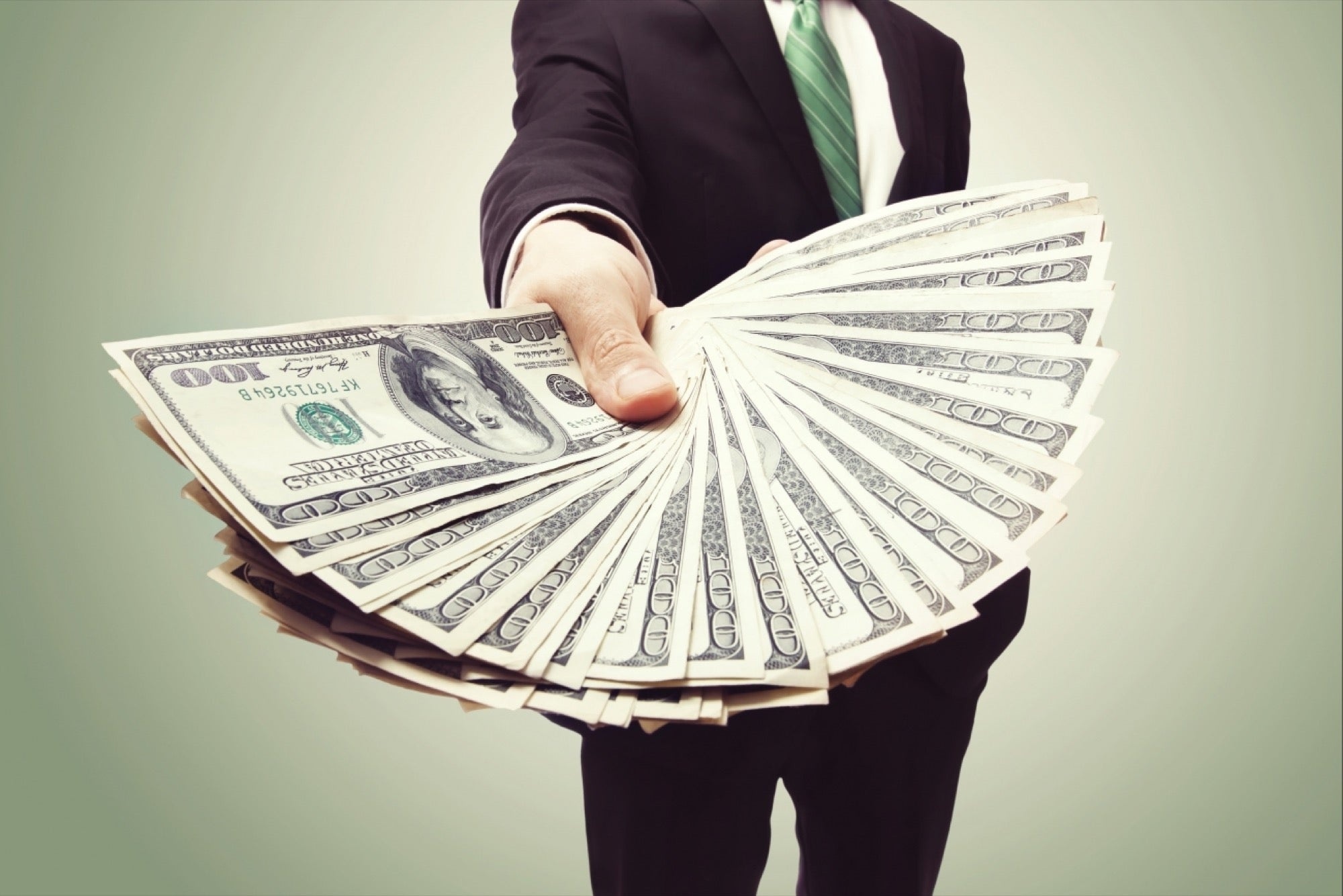 Businessman fanning hundred-dollar bills, Dark suit green tie, Cash-in-hand display Businessman fanning hundred-dollar bills, Dark suit green tie, Cash-in-hand display — 2000×1334 HD wallpaper
