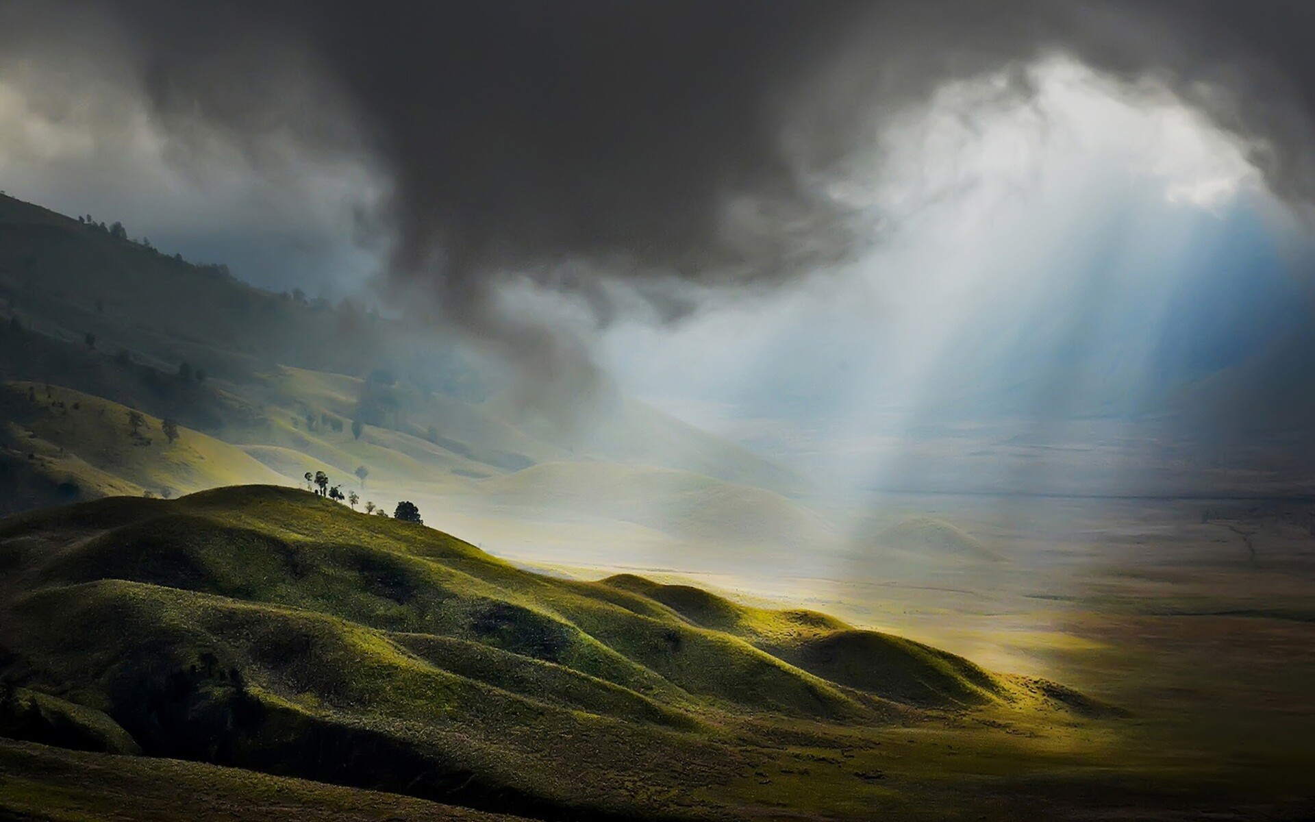 Mount Bromo savanna hills, Sunbeams piercing storm clouds, Misty green valley Mount Bromo savanna hills, Sunbeams piercing storm clouds, Misty green valley — 1920×1200 HD wallpaper