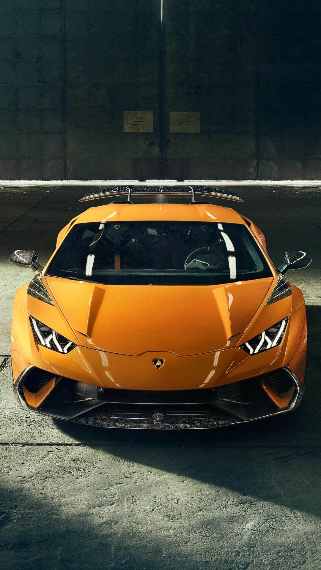 Orange Huracan Performante, Carbon rear wing, High-angle hangar view Orange Huracan Performante, Carbon rear wing, High-angle hangar view — 1080×1920 HD wallpaper