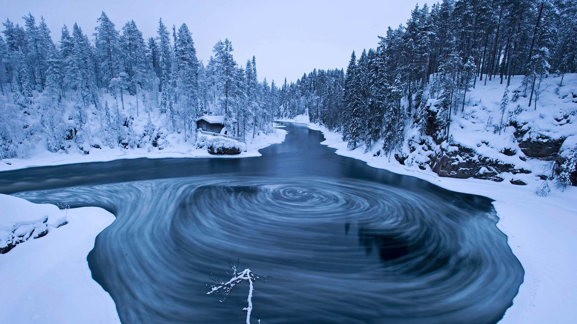 Oulanka National Park river, Snow-covered pine forest, Swirling icy water vortex Oulanka National Park river, Snow-covered pine forest, Swirling icy water vortex — 1920×1080 HD wallpaper