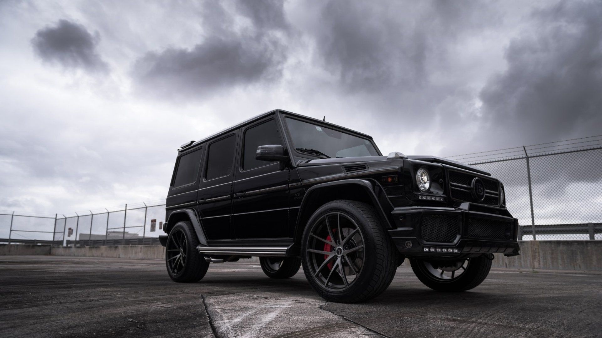 All-black Brabus G63, Red brake calipers, Stormy overcast sky All-black Brabus G63, Red brake calipers, Stormy overcast sky — 1920×1080 HD wallpaper