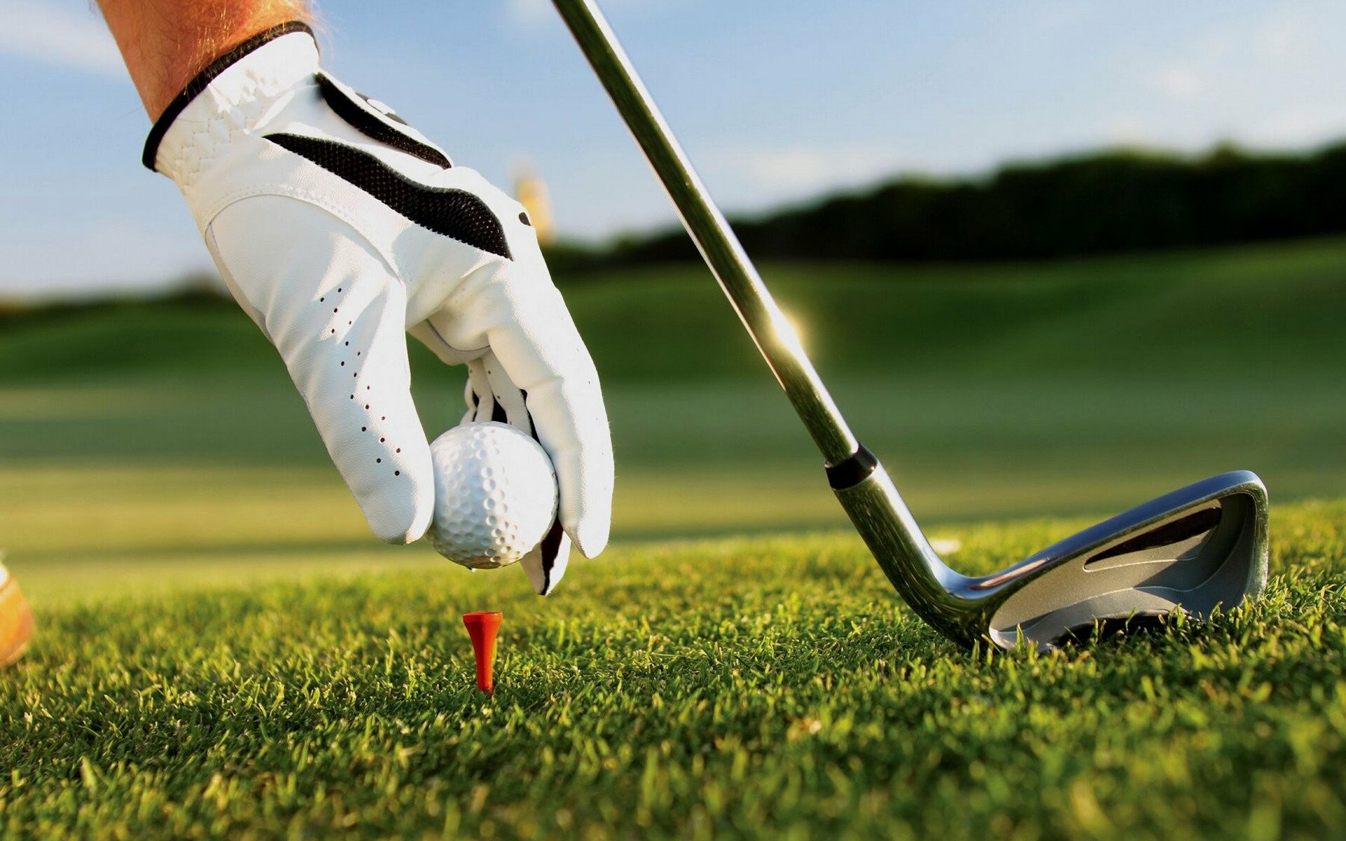 Gloved hand placing ball, Golf club iron, Red tee on fairway Gloved hand placing ball, Golf club iron, Red tee on fairway — 1920×1200 HD wallpaper