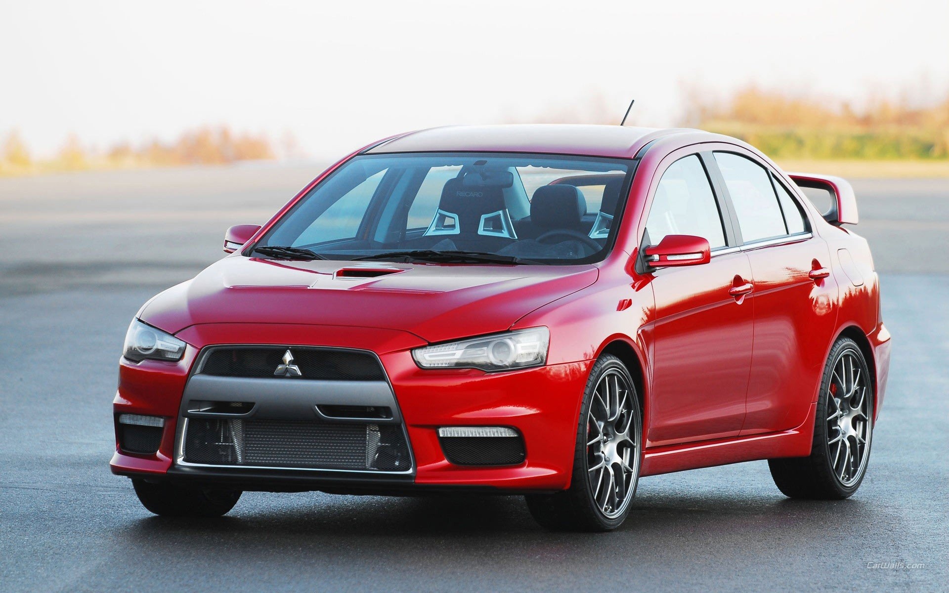 Mitsubishi Lancer Evolution X, Red sport sedan, Empty asphalt lot Mitsubishi Lancer Evolution X, Red sport sedan, Empty asphalt lot — 1920×1200 HD wallpaper