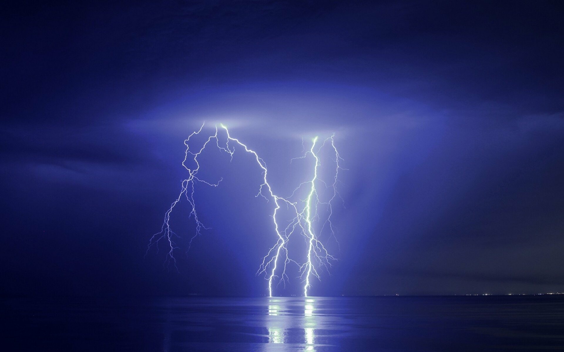 Twin lightning bolts, Stormy night ocean, Distant coastal lights Twin lightning bolts, Stormy night ocean, Distant coastal lights — 1920×1200 HD wallpaper