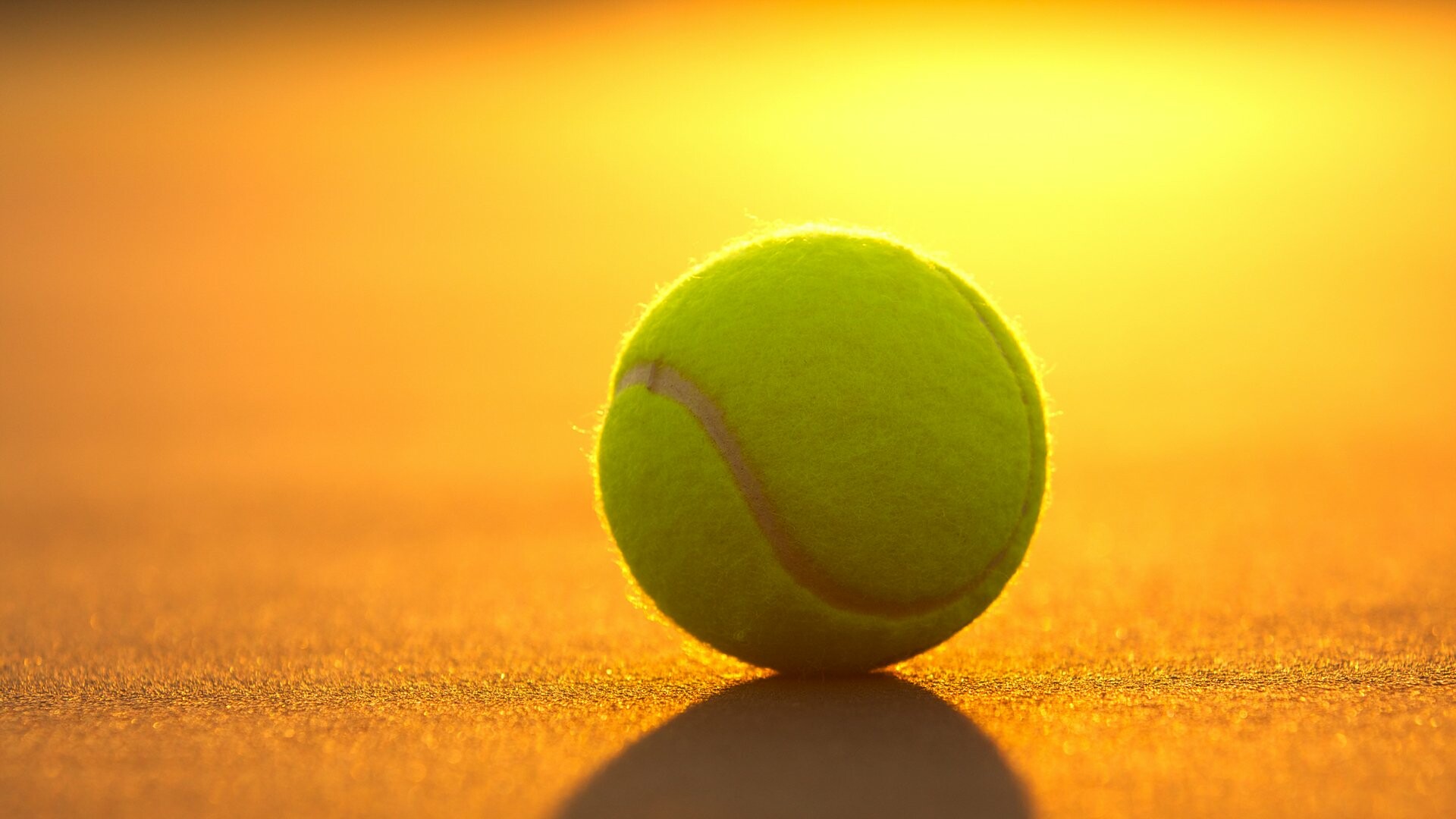 Yellow tennis ball, Clay court surface, Sunset backlight Yellow tennis ball, Clay court surface, Sunset backlight — 1920×1080 HD wallpaper