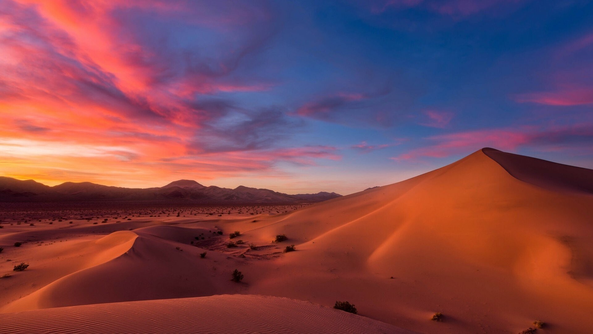 Sculpted sand dunes, Pink sunset clouds, Distant desert mountains Sculpted sand dunes, Pink sunset clouds, Distant desert mountains — 1920×1080 HD wallpaper