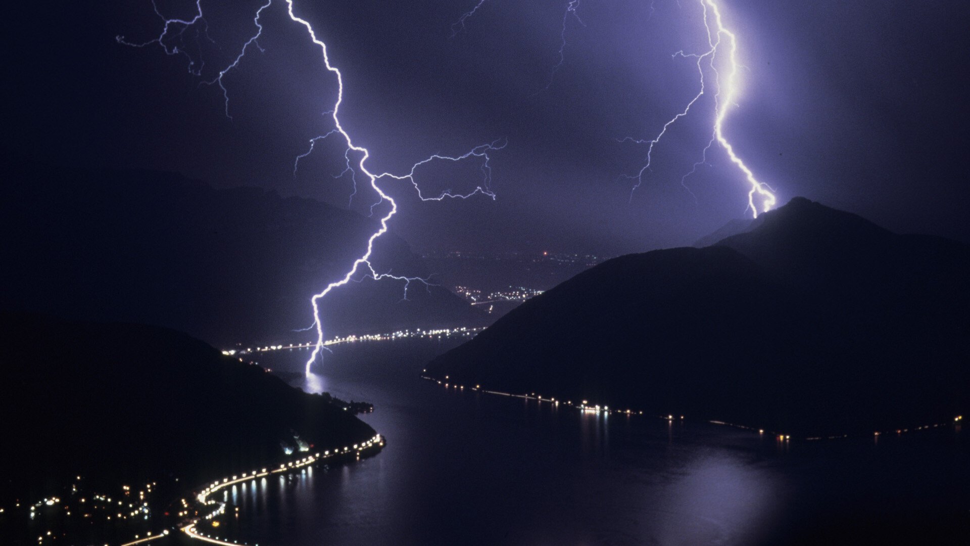 Twin lightning bolts, Mountain lake valley, Illuminated shoreline towns Twin lightning bolts, Mountain lake valley, Illuminated shoreline towns — 1920×1080 HD wallpaper